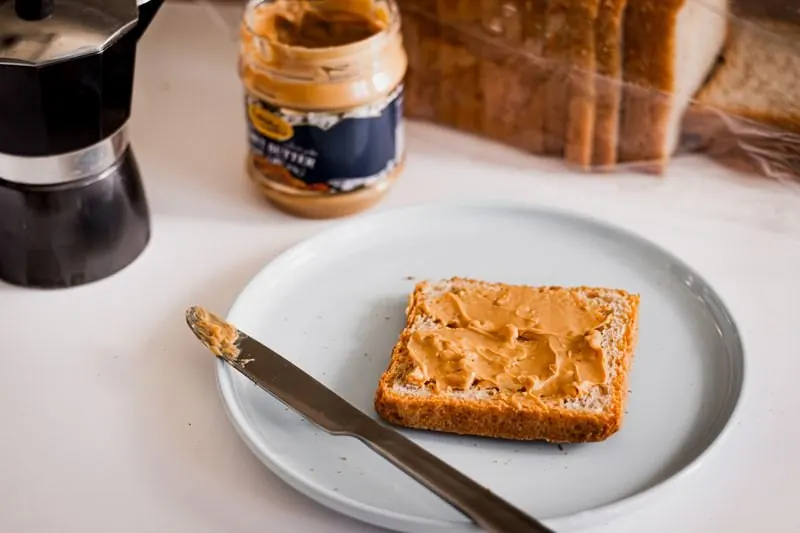 Creamy peanut butter spread on bread